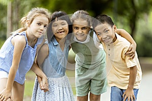 Group of asian and caucasian kids having fun in the park