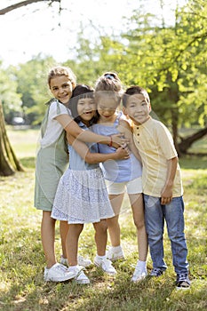 Group of asian and caucasian kids having fun in the park