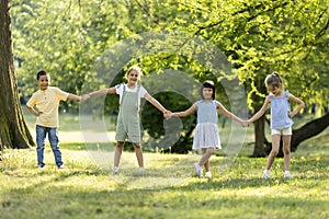 Group of asian and caucasian kids having fun in the park