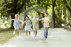Group of asian and caucasian kids having fun in the park