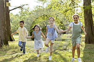 Group of asian and caucasian kids having fun in the park