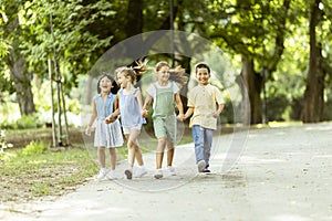 Group of asian and caucasian kids having fun in the park