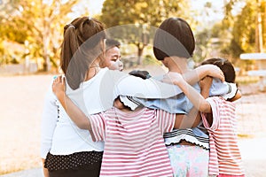 Group of asian children hugging and playing together