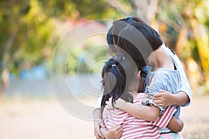 Group of asian children hugging and playing together