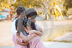 Group of asian children hugging and playing together