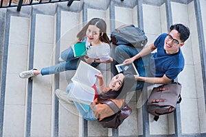 Group of Asian college student using tablet and mobile phone outside classroom. Happiness and Education learning concept. Back to