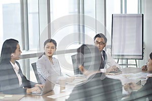 Group of asian corporate executives discussing business in conference room