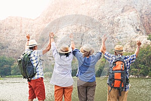 A group of Asian elders standing on high mountains enjoying nature