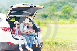 Group asian family children checking map and pointing on the car adventure and tourism for destination leisure trips travel for ed