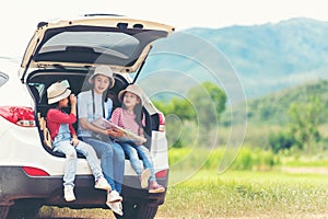 Group asian family children checking map and pointing on the car adventure and tourism for destination and leisure trips travel fo photo