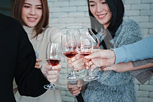 Group of asian friends enjoy having party and drinking wine together