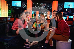 Group of asian friends having fun and celebration at karaoke club,