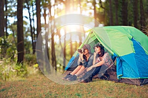 A group of Asian friends tourist take photo together with happiness in Summer while having camping