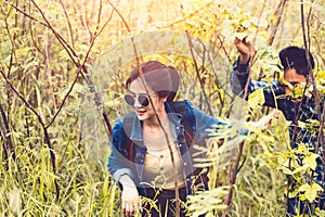 Group of Asian friendship adventure in forest jungle view background. Girl leading tourism team in nature. People lifestyle travel