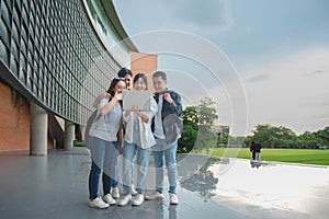 Group of Asian male and female students Standing and talking and reviewing lessons together