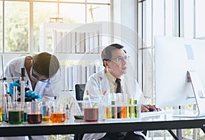 Group of asian scientist working and explaining research information together in the laboratary