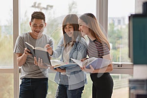 Group of asian students researching data for homework assignment in library