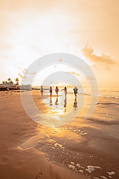 a group of Asian teenagers running with happy expressions on vacation with their friends drunk on the beach