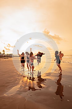 a group of Asian teenagers running with happy expressions on vacation with their friends drunk on the beach