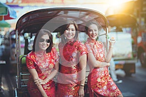 Group of asian woman wearing chinese tradition clothes toothy smiling face happiness emotion and hand sign i love you