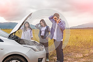 Group of Asian young having trouble car engine overheating and have smoke in parks outdoor