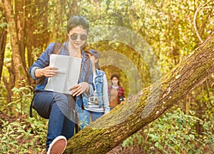 Group of asian young woman with backpack trekking adventure and camping in forest