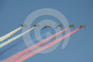 A group of assault plane Sukhoi Su-25 Grach NATO reporting name: `Frogfoot` in the sky smoke colors of Russian flag at the rehea