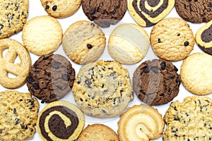 A group of assorted cookies. Chocolate chip, oatmeal, raisin, Danish cookies and biscuits in the shape of a spiral pattern close-u