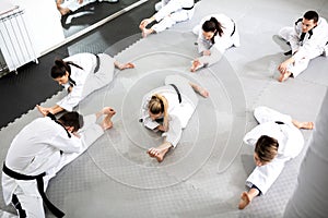 Group of athletes accompanied with physically challenged athlete preparing for a combat training workout photo