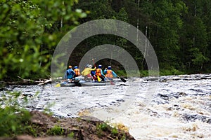 Group of athletes floats on an inflatable catamaran