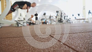Group of athletic people training on sports equipment at fitness club center. Young sportsmen and sportswomen workout at