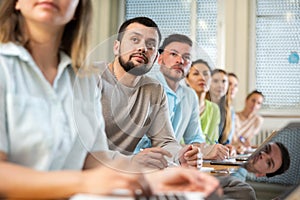 Group of attentive students writes synopsis in copybooks