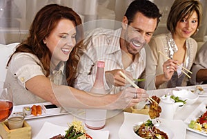 Group of attractive people eating and socializing