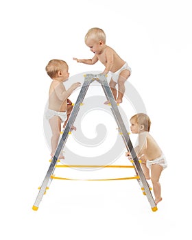 Group of babies climbing on stepladder over white