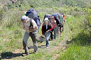 Group of backpacker moving up on mountain