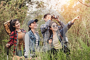 Group of backpacking hikers friends going for forest trekking