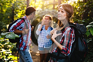 Group of backpacking hikers going for forest trekking