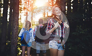 Group of backpacking hikers going for forest trekking