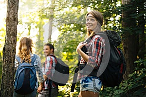 Group of backpacking hikers going for forest trekking