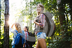 Group of backpacking hikers going for forest trekking