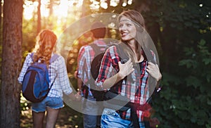 Group of backpacking hikers going for forest trekking