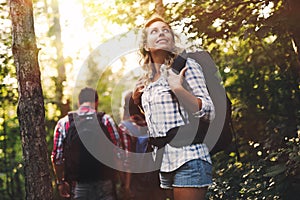 Group of backpacking hikers going for forest trekking