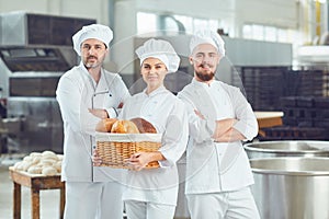 A group of bakers smiles at the bakery