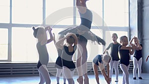Group of ballet dancers jumping in the air. Young ballerinas in training. School of ballet..