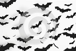 A group of bats flying through the air at night