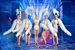 Group of beautiful female dancers in white carnival costumes