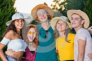 Group of beautiful teenagers hugging each other at party.