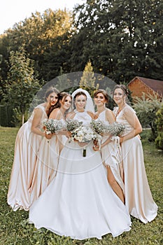 A group of beautiful women in matching dresses are smiling, celebrating, and having fun together