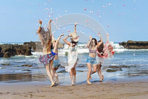 group of beautiful young women having fun and throwing up petals