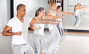 Group of beginners mastering martial arts for self defence in gym